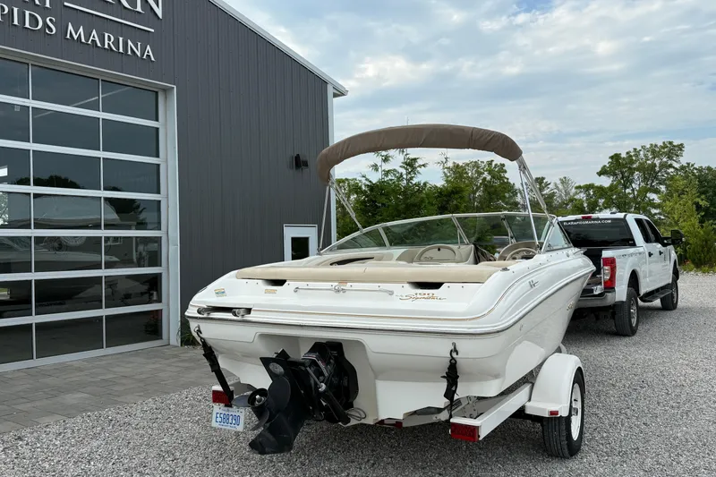Slide: The Image of 1998 Sea Ray 190 Bow Rider boat on trailer, parked outside marina. - 2