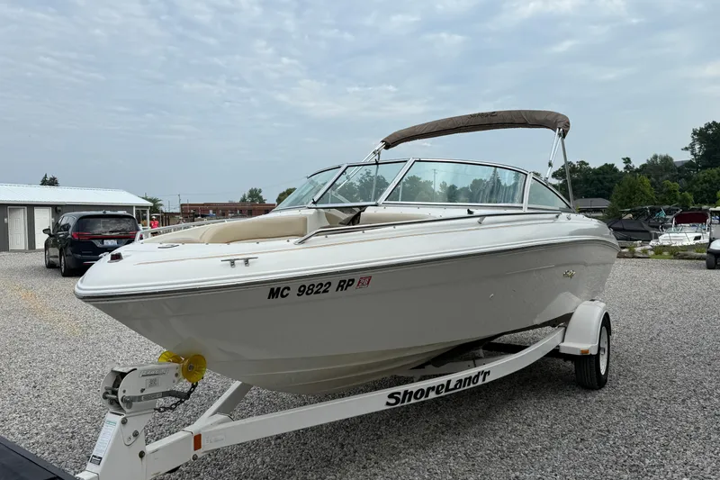 Slide: The Image of 1998 Sea Ray 190 Bow Rider boat on trailer in outdoor setting. - 7