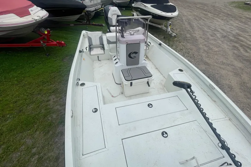 Slide: The Image of 2021 Crestliner 2000 Bay boat interior with seating and storage compartments. - 12