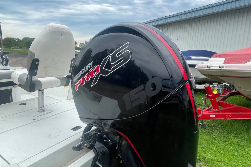 Slide: The Image of Mercury Pro XS 150 engine on 2021 Crestliner 2000 Bay boat, parked outdoors. - 14