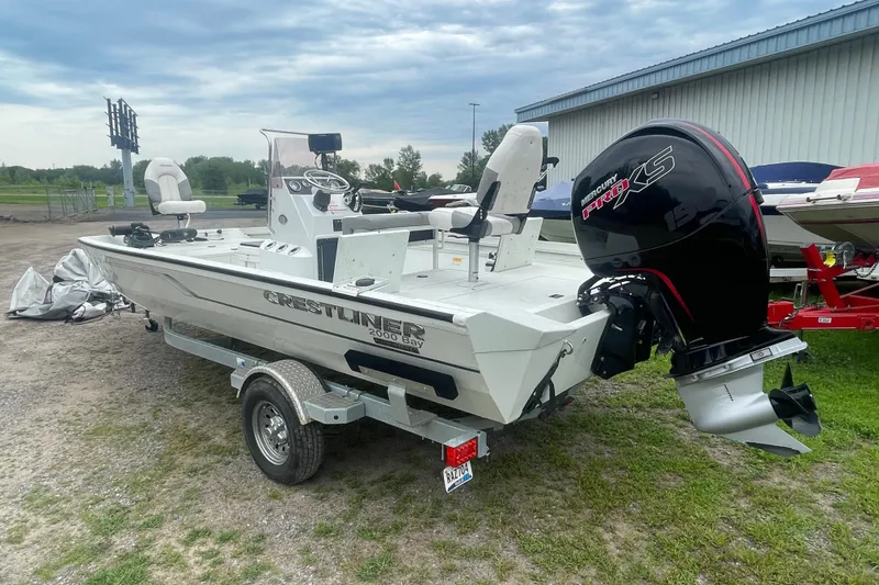 Slide: The Image of 2021 Crestliner 2000 Bay boat with Mercury engine on trailer, parked outdoors. - 4