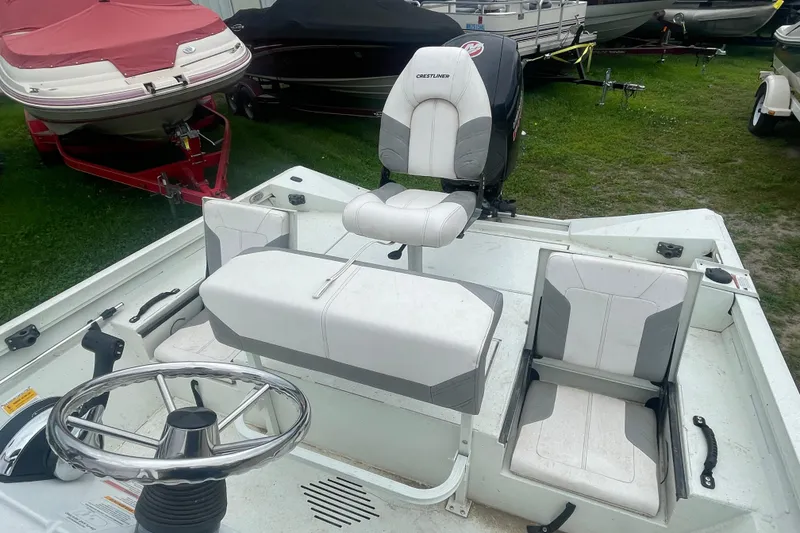 Slide: The Image of 2021 Crestliner 2000 Bay boat interior with seating and steering wheel. - 8