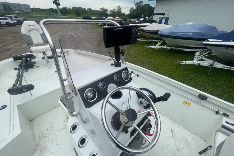 Slide: The Image of 2021 Crestliner 2000 Bay boat interior with steering wheel and control panel. - 9