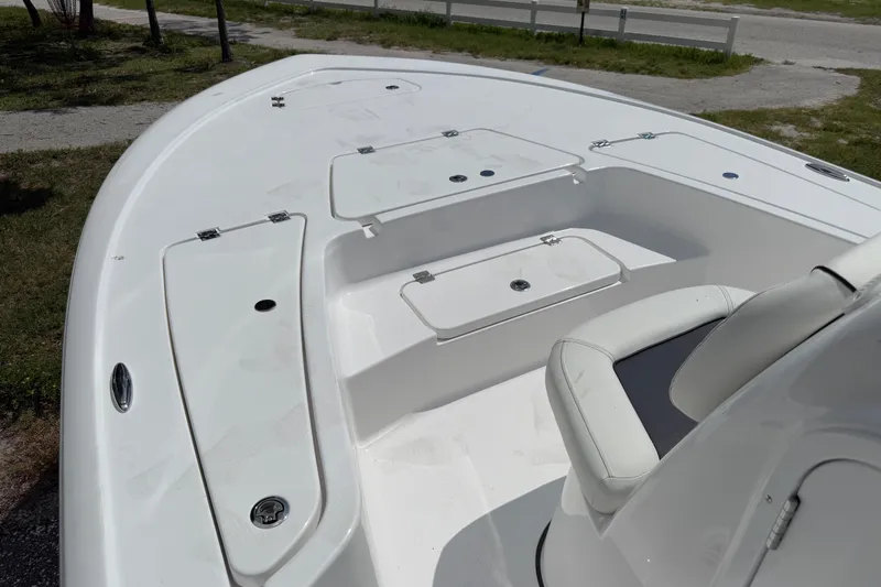 Slide: The Image of 2026 Tidewater 2110 Bay Max boat interior with seating and storage compartments. - 11