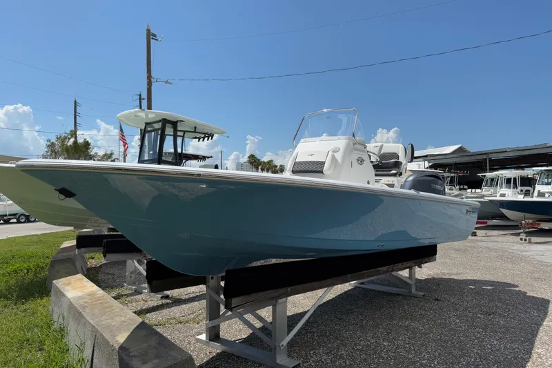 Slide: The Image of 2026 Tidewater 2110 Bay Max boat displayed outdoors on a sunny day. - 2