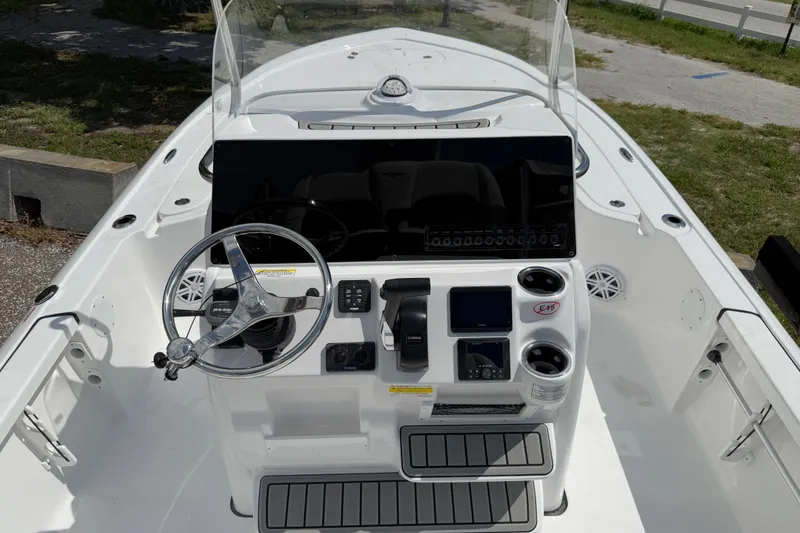 Slide: The Image of 2026 Tidewater 2110 Bay Max boat console with steering wheel and navigation controls. - 4