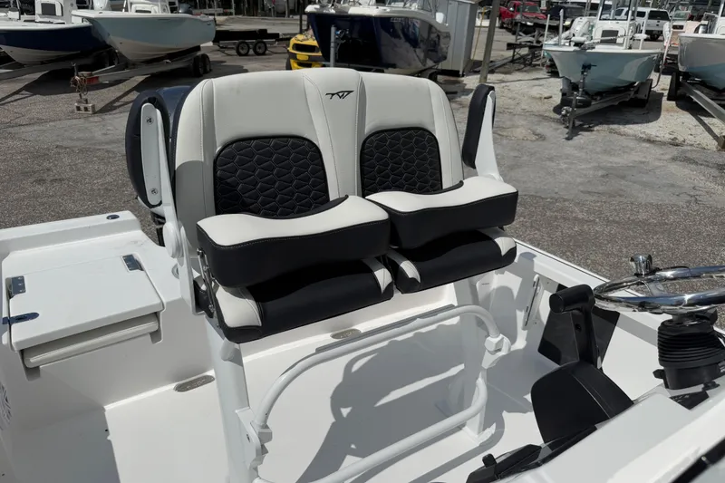 Slide: The Image of 2026 Tidewater 2110 Bay Max boat interior with dual black and white cushioned seats. - 7