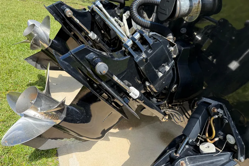 Slide: The Image of Close-up of a 2005 Apache 36CC boat engine and propellers on grass. - 11