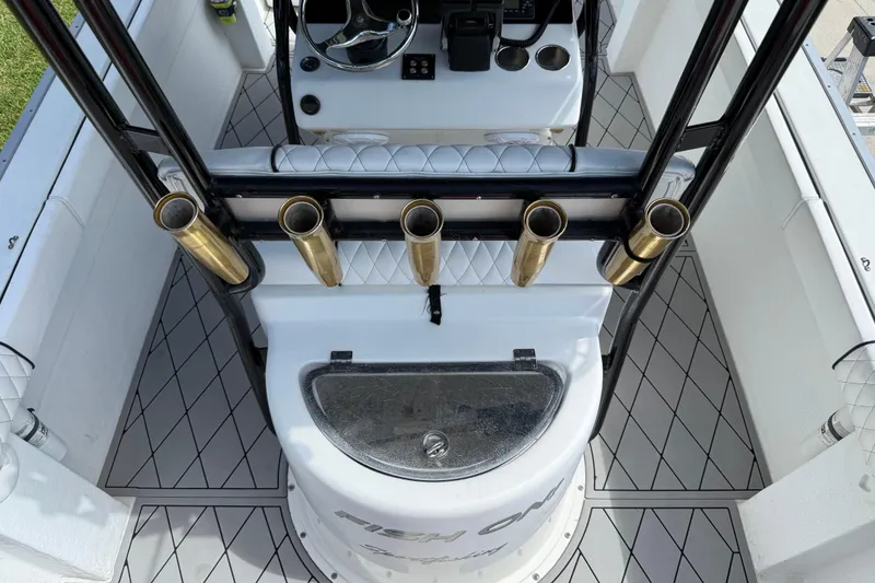 Slide: The Image of 2005 Apache 36CC boat interior with rod holders and steering console. - 15