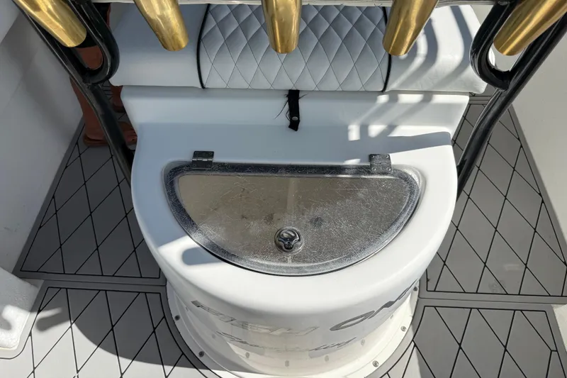 Slide: The Image of Fishing rod holders and storage compartment on a 2005 Apache 36CC boat deck. - 16