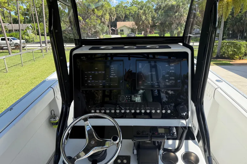 Slide: The Image of Cockpit view of a 2005 Apache 36CC boat with modern navigation controls. - 18
