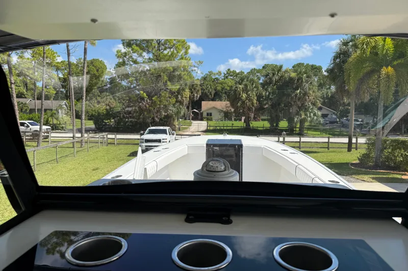 Slide: The Image of View from Apache 36CC boat, 2005 model, showing deck and lush surroundings. - 20