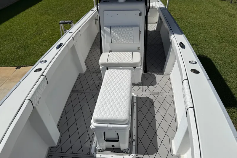 Slide: The Image of Interior of 2005 Apache 36CC boat with white quilted seating and diamond-patterned flooring. - 24