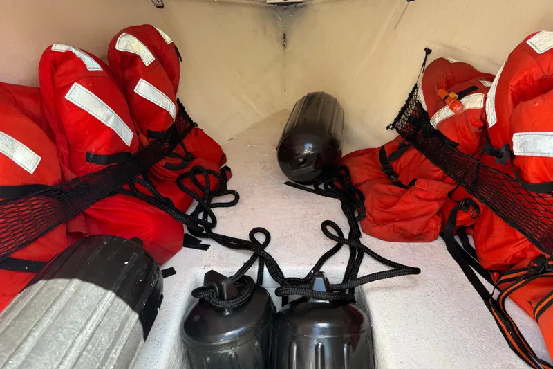 Slide: The Image of Storage area of a 2005 Apache 36CC boat with life jackets and fenders. - 25