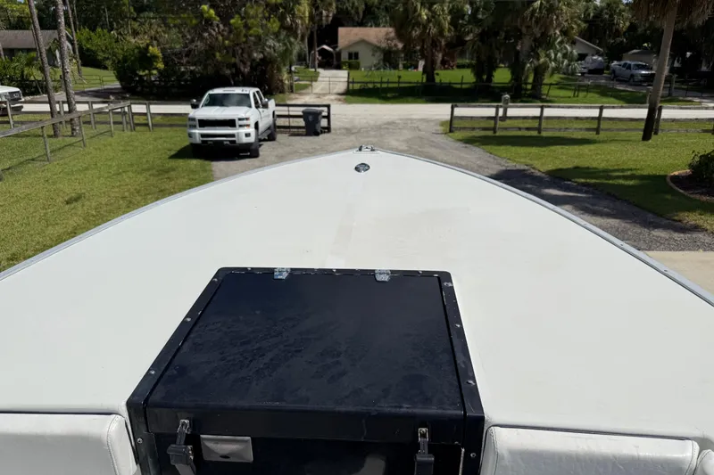 Slide: The Image of Bow of 2005 Apache 36CC boat with parked white truck in background. - 26