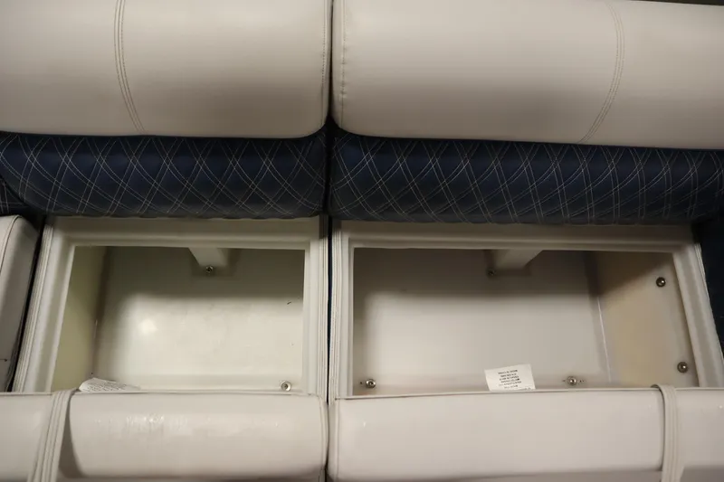 Slide: The Image of 2023 Nepallo 20 CW Pontoon storage compartments with white and blue cushioned seating. - 15