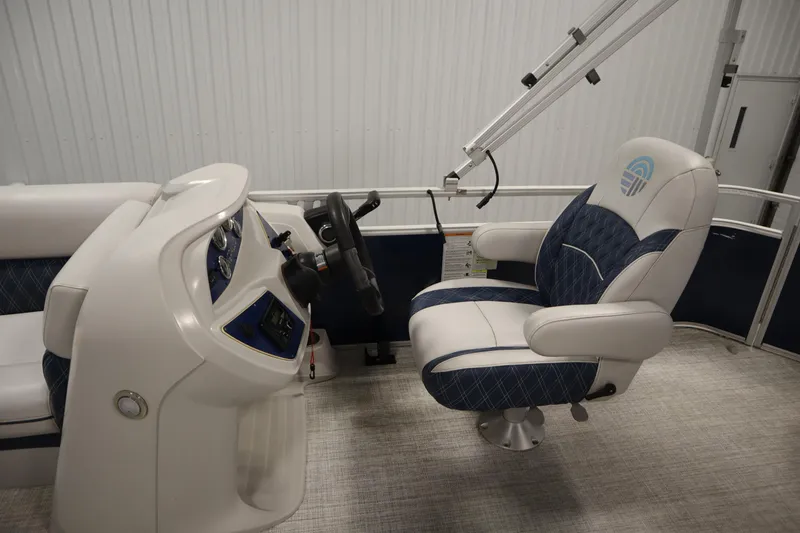 Slide: The Image of 2023 Nepallo 20 CW Pontoon interior with captain's chair and steering console. - 17