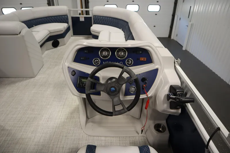 Slide: The Image of 2023 Nepallo 20 CW Pontoon boat interior with steering console and seating. - 18