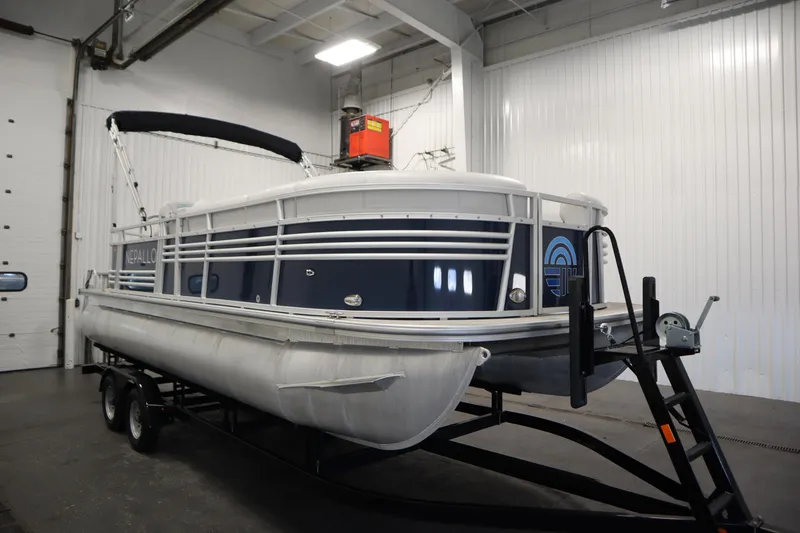 Slide: The Image of 2023 Nepallo 20 CW Pontoon boat on trailer in indoor storage facility. - 2