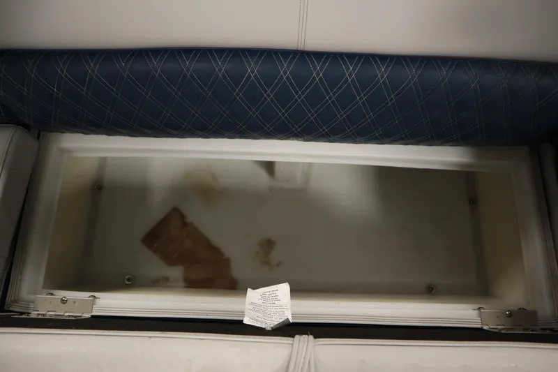 Slide: The Image of Open storage compartment in 2023 Nepallo 20 CW Pontoon boat with blue cushioned seating. - 29