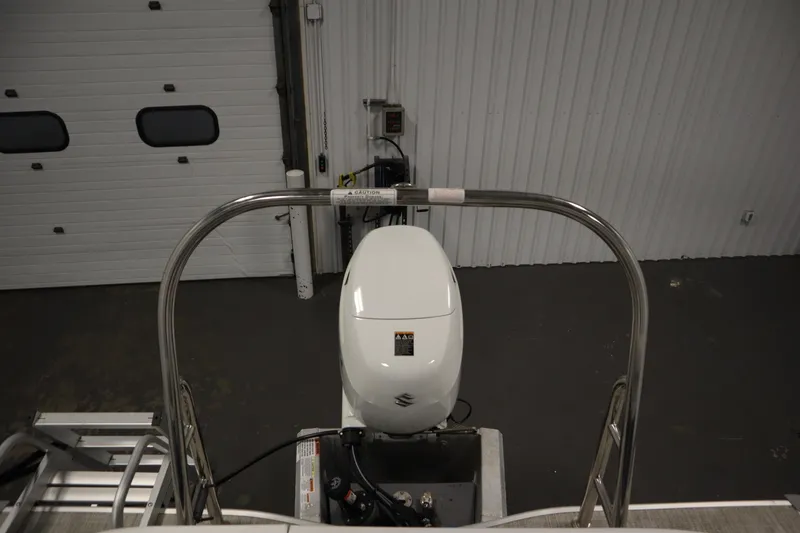 Slide: The Image of 2023 Nepallo 20 CW Pontoon with Suzuki outboard motor in a garage setting. - 32