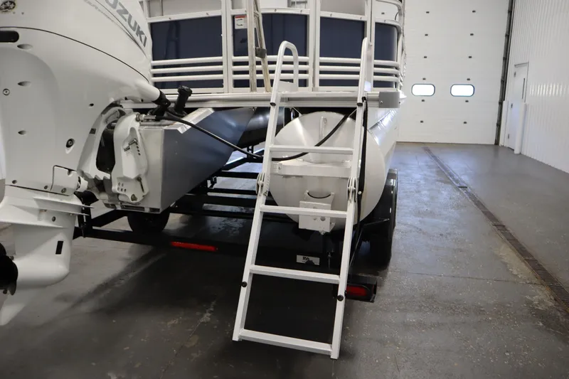 Slide: The Image of 2023 Nepallo 20 CW Pontoon with Suzuki outboard motor in a garage setting. - 33
