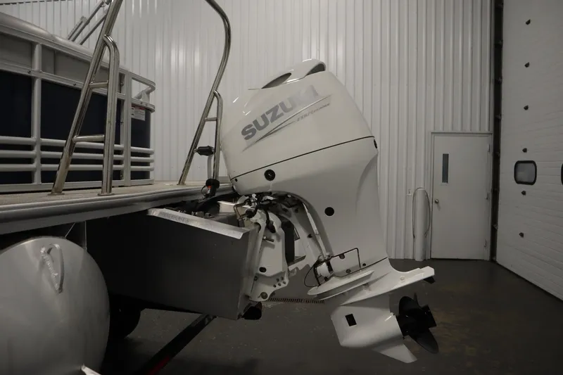 Slide: The Image of 2023 Nepallo 20 CW Pontoon with Suzuki outboard motor in a garage setting. - 34