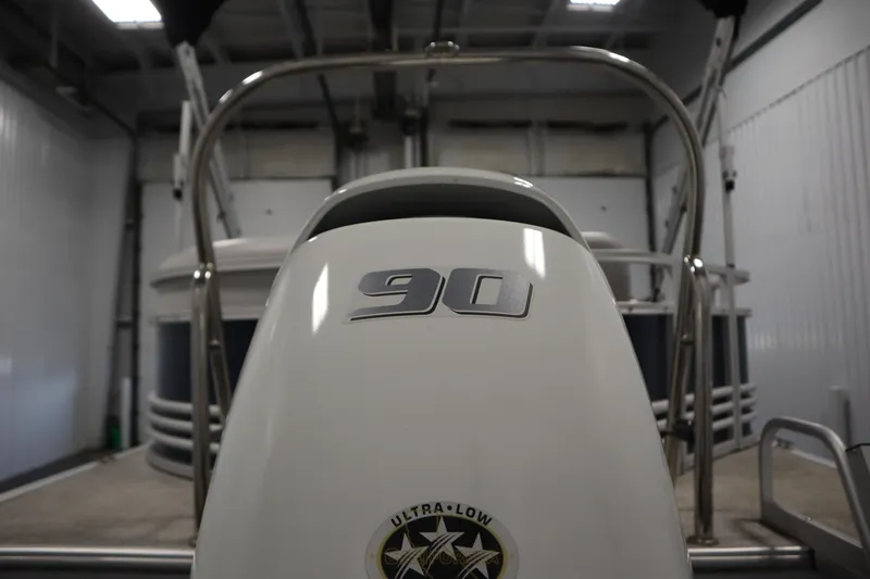 Slide: The Image of 2023 Nepallo 20 CW Pontoon boat engine with "90" horsepower label in a garage setting. - 36