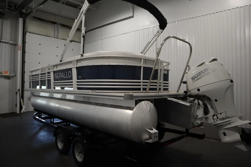Slide: The Image of 2023 Nepallo 20 CW Pontoon boat with Suzuki outboard motor in indoor storage. - 6