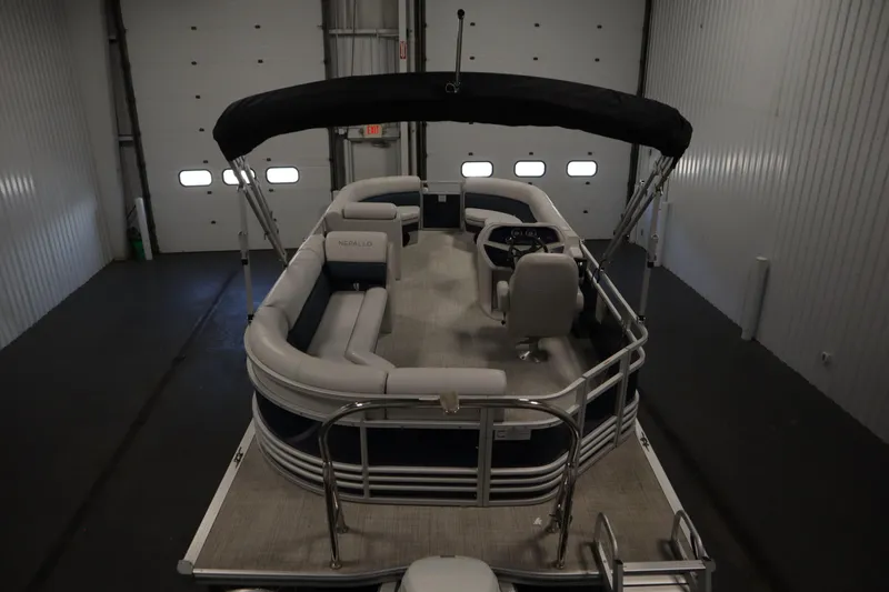 Slide: The Image of 2023 Nepallo 20 CW Pontoon boat in indoor storage, featuring spacious seating and canopy. - 9
