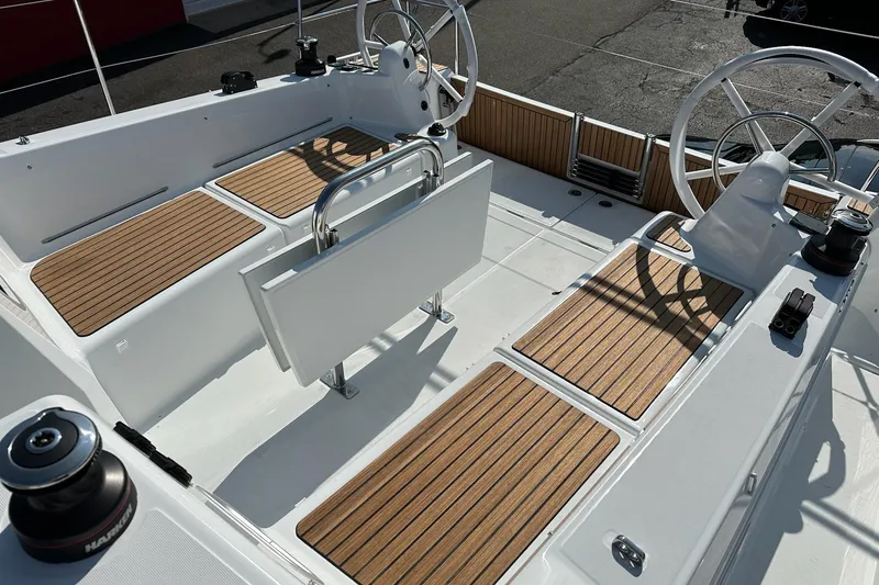 Slide: The Image of 2025 Jeanneau Sun Odyssey 380 cockpit with dual steering wheels and teak flooring. - 11