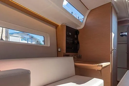 Slide: The Image of Interior of 2025 Jeanneau Sun Odyssey 380 yacht with modern seating and wooden accents. - 14