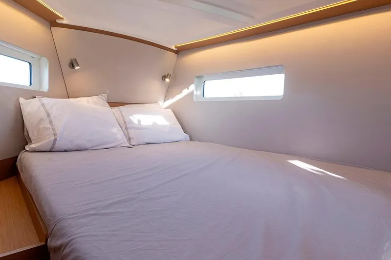 Slide: The Image of Cozy cabin interior of 2025 Jeanneau Sun Odyssey 380 yacht with natural light. - 17