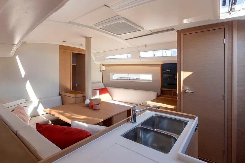 Slide: The Image of Interior of 2025 Jeanneau Sun Odyssey 380 yacht, featuring modern design and cozy seating area. - 19