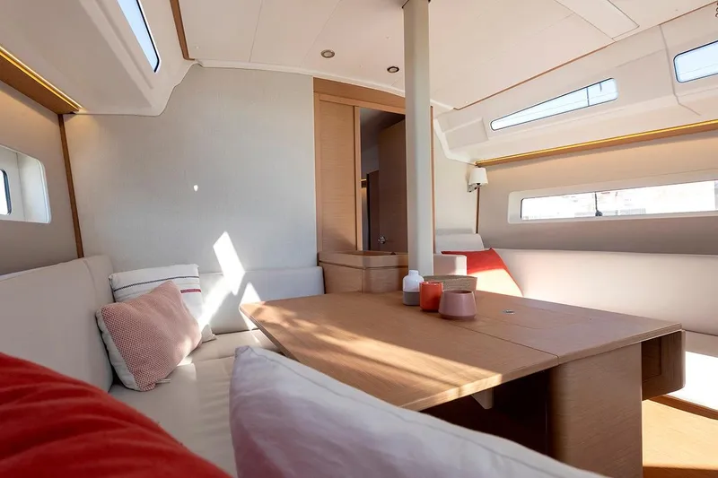 Slide: The Image of Interior of 2025 Jeanneau Sun Odyssey 380 yacht, featuring modern seating and natural light. - 21