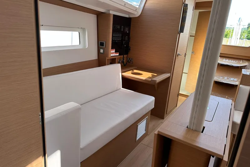 Slide: The Image of Interior of 2025 Jeanneau Sun Odyssey 380 yacht, featuring modern seating and wooden finishes. - 31