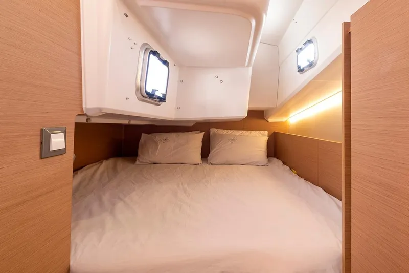 Slide: The Image of Cozy cabin interior of 2025 Jeanneau Sun Odyssey 380 sailboat with comfortable bedding. - 32