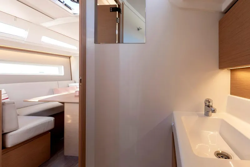 Slide: The Image of Interior of 2025 Jeanneau Sun Odyssey 380, featuring modern sink and cozy seating area. - 35