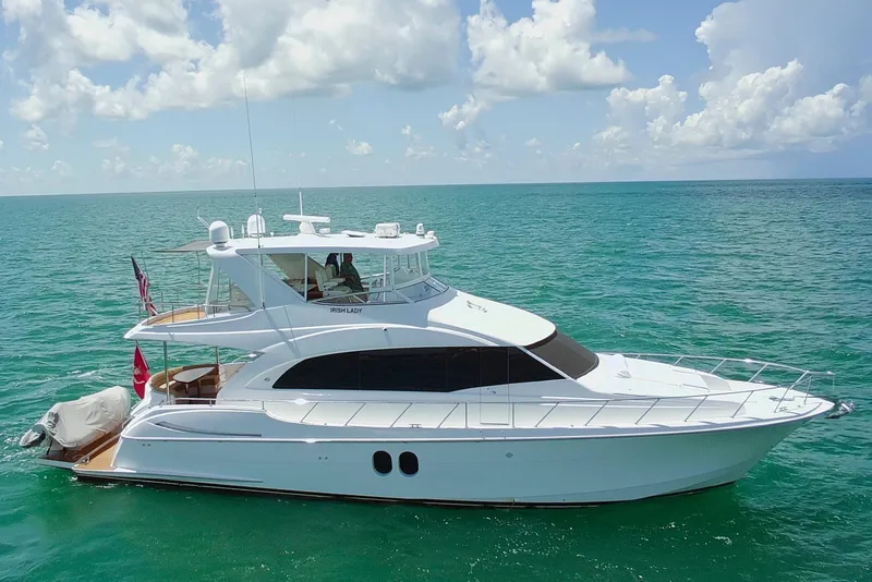 Slide: The Image of 2009 Hatteras 60 Motor Yacht cruising on clear blue ocean waters. - 0