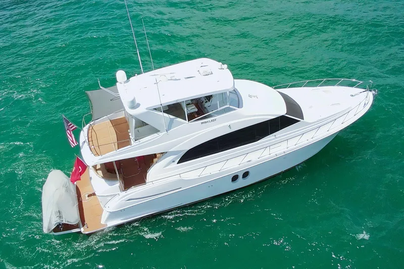 Slide: The Image of 2009 Hatteras 60 Motor Yacht cruising on turquoise waters. - 1