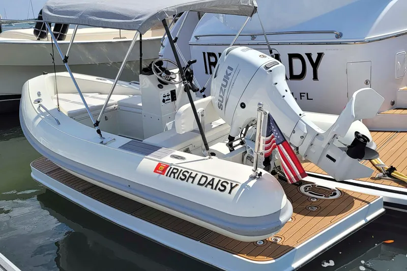 Slide: The Image of ```json { "alt_text": "2009 Hatteras 60 Motor Yacht with Suzuki engine and American flag." } ``` - 10