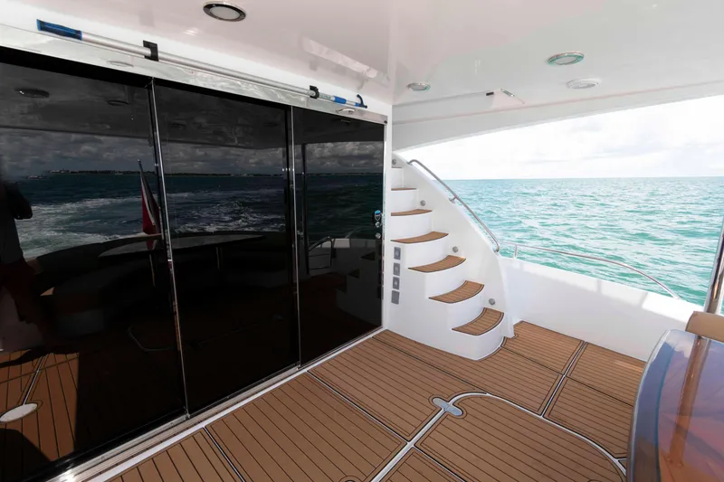 Slide: The Image of Luxurious 2009 Hatteras 60 Motor Yacht deck with elegant wooden flooring and ocean view. - 13