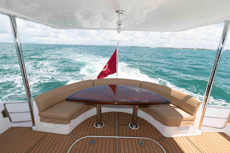 Slide: The Image of 2009 Hatteras 60 Motor Yacht aft deck with curved seating and ocean view. - 14