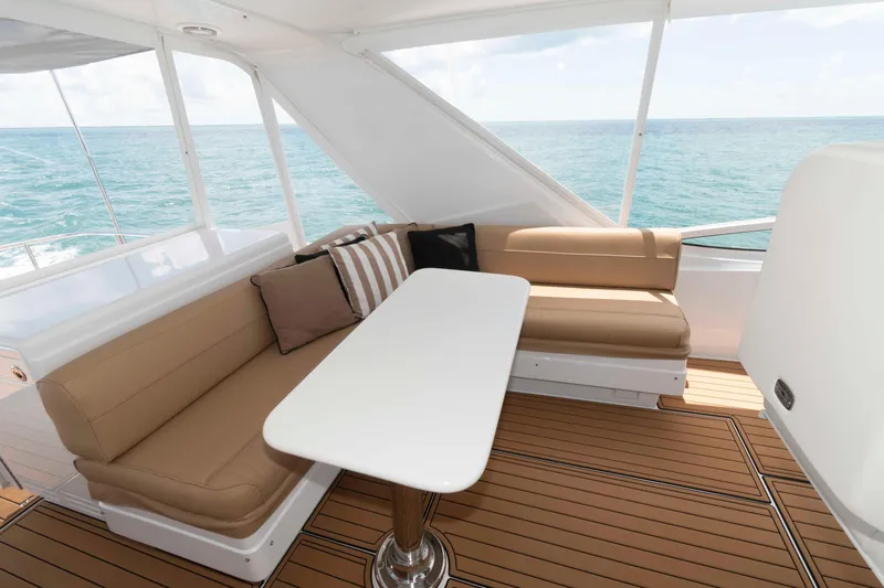 Slide: The Image of Luxurious seating area on 2009 Hatteras 60 Motor Yacht with ocean view. - 18