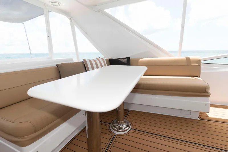 Slide: The Image of Interior of 2009 Hatteras 60 Motor Yacht with elegant seating and table. - 19