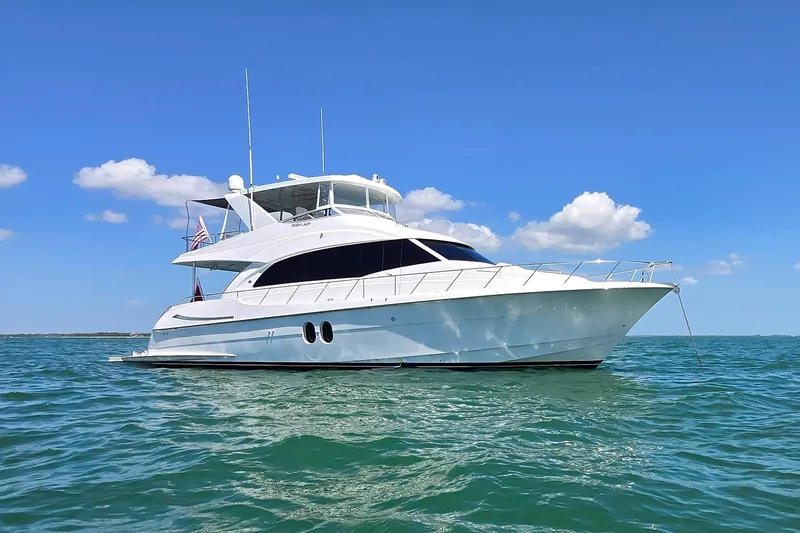 Slide: The Image of 2009 Hatteras 60 Motor Yacht on open water under clear blue sky. - 2
