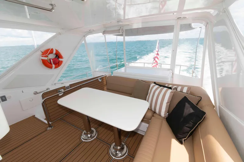 Slide: The Image of Luxurious 2009 Hatteras 60 Motor Yacht interior with ocean view and comfortable seating. - 25