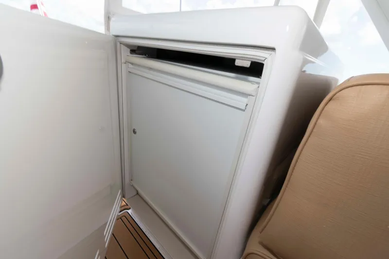 Slide: The Image of Interior view of 2009 Hatteras 60 Motor Yacht, featuring a compact built-in refrigerator. - 26
