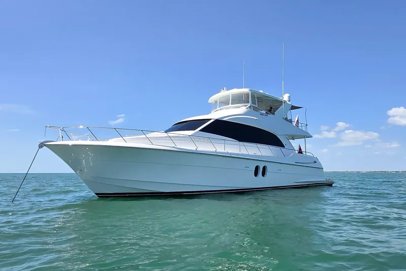 Slide: The Image of Luxurious 2009 Hatteras 60 Motor Yacht on calm blue waters under clear sky. - 3