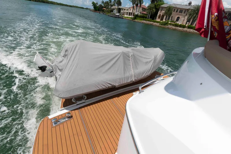 Slide: The Image of 2009 Hatteras 60 Motor Yacht cruising with covered dinghy on deck. - 31